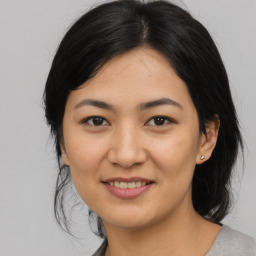 Joyful asian young-adult female with medium  black hair and brown eyes