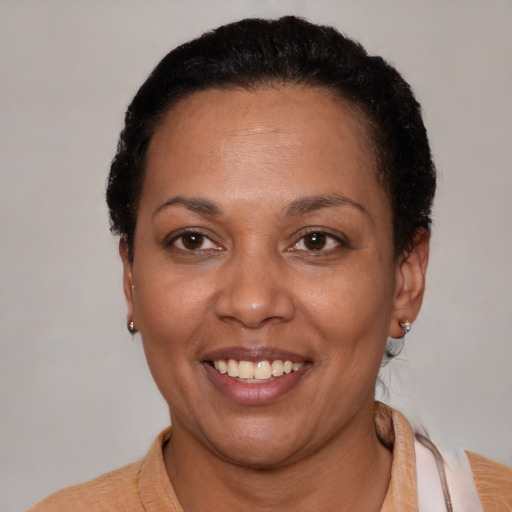 Joyful latino adult female with short  black hair and brown eyes