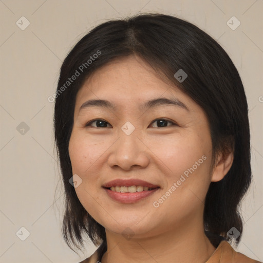 Joyful asian adult female with medium  brown hair and brown eyes