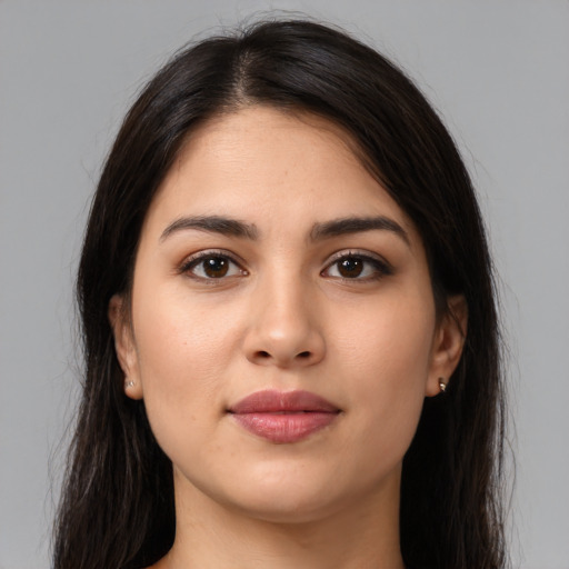 Joyful latino young-adult female with long  brown hair and brown eyes