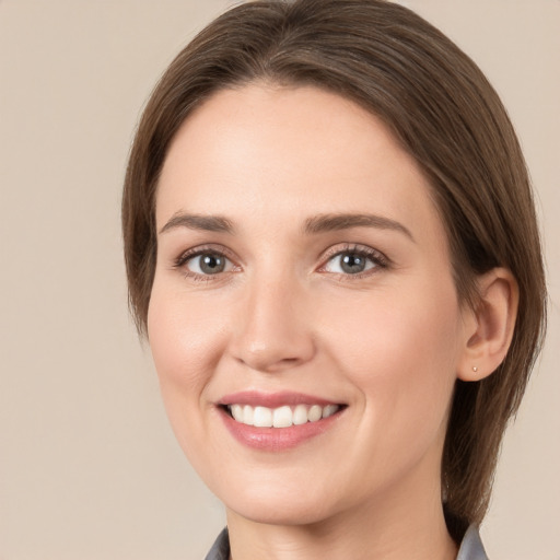 Joyful white young-adult female with medium  brown hair and grey eyes