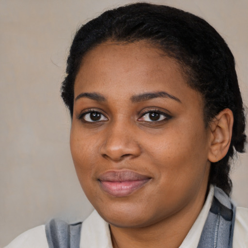 Joyful black young-adult female with medium  black hair and brown eyes