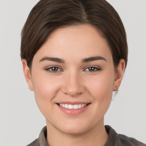 Joyful white young-adult female with short  brown hair and brown eyes