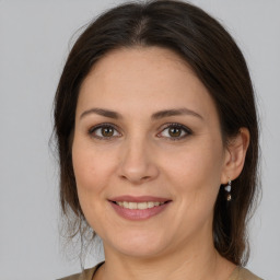 Joyful white adult female with medium  brown hair and brown eyes