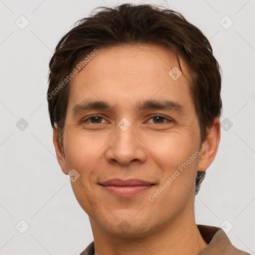 Joyful white adult male with short  brown hair and brown eyes