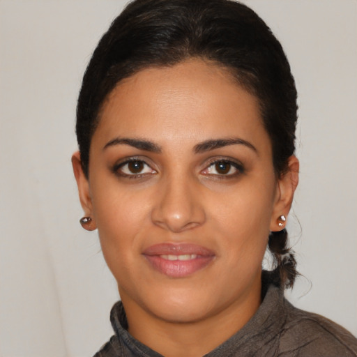 Joyful latino young-adult female with short  brown hair and brown eyes
