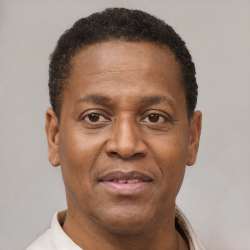 Joyful latino adult male with short  brown hair and brown eyes