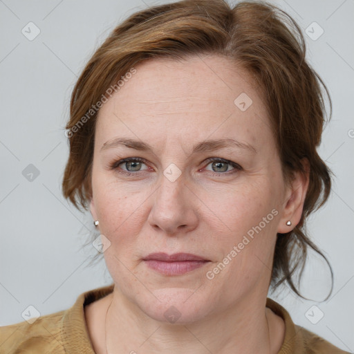 Joyful white adult female with medium  brown hair and blue eyes