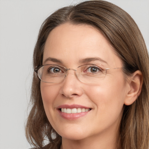 Joyful white adult female with long  brown hair and brown eyes