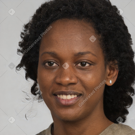 Joyful black young-adult female with long  black hair and brown eyes