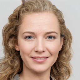 Joyful white young-adult female with long  brown hair and blue eyes