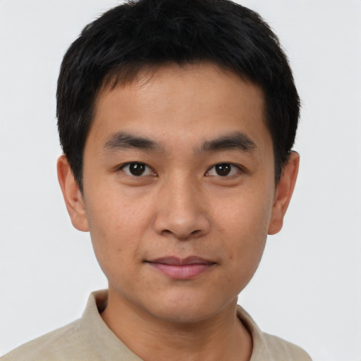 Joyful white young-adult male with short  black hair and brown eyes