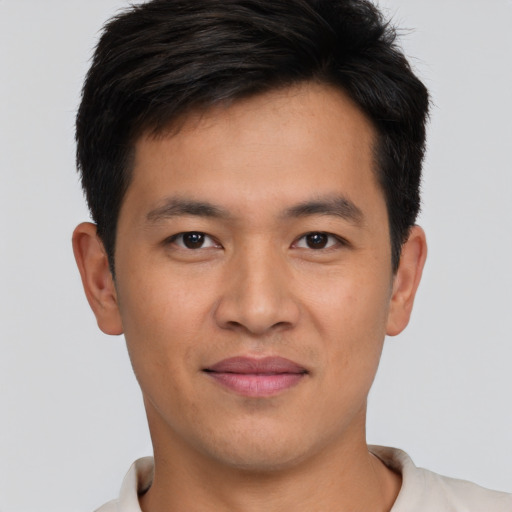 Joyful asian young-adult male with short  brown hair and brown eyes