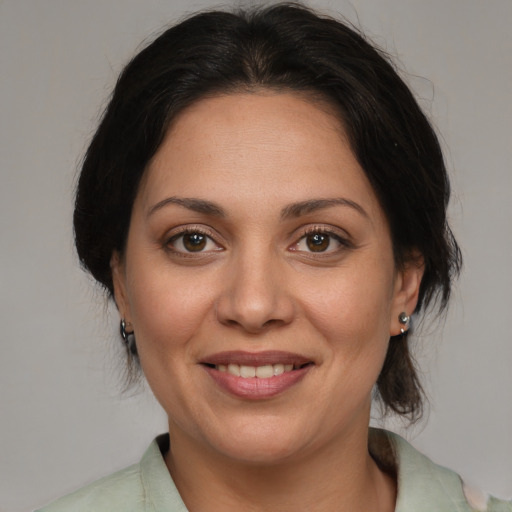 Joyful white adult female with medium  brown hair and brown eyes