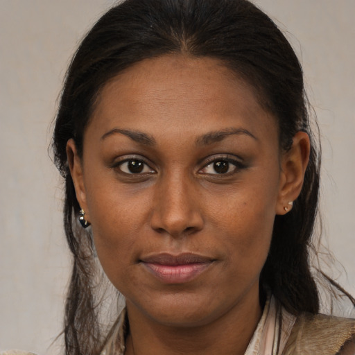 Joyful black young-adult female with medium  brown hair and brown eyes