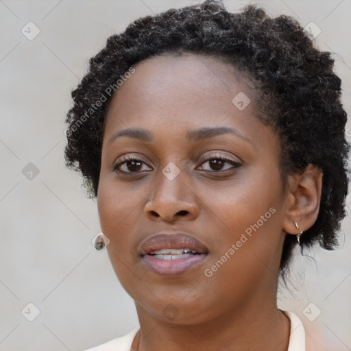 Joyful black young-adult female with long  brown hair and brown eyes