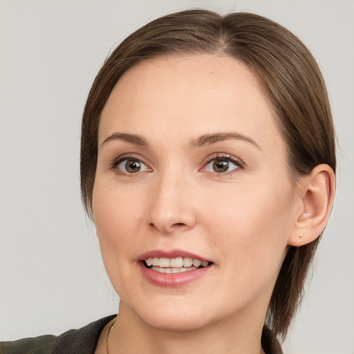 Joyful white young-adult female with medium  brown hair and grey eyes