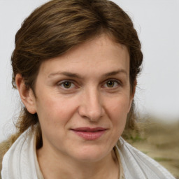 Joyful white adult female with medium  brown hair and grey eyes