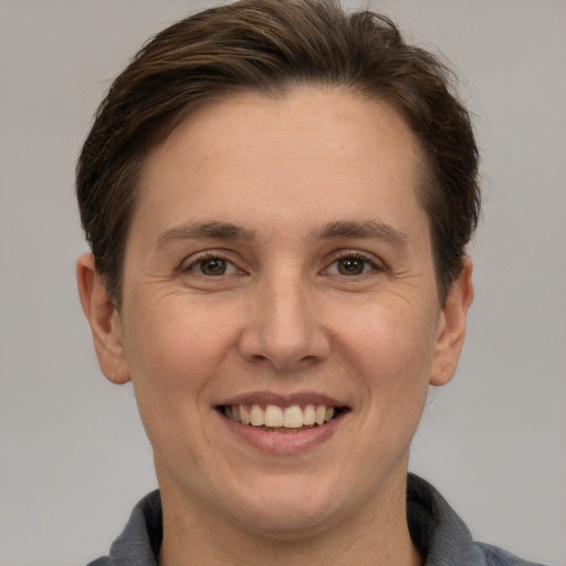 Joyful white adult female with short  brown hair and grey eyes