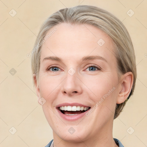 Joyful white adult female with medium  brown hair and blue eyes