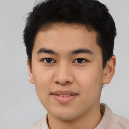 Joyful asian young-adult male with short  brown hair and brown eyes