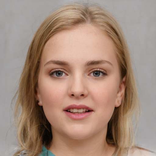 Joyful white young-adult female with medium  brown hair and blue eyes