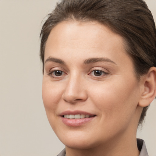 Joyful white young-adult female with medium  brown hair and brown eyes