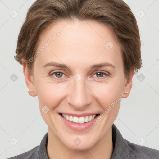 Joyful white young-adult female with short  brown hair and grey eyes