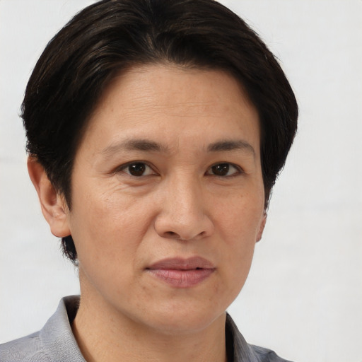 Joyful white adult female with short  brown hair and brown eyes