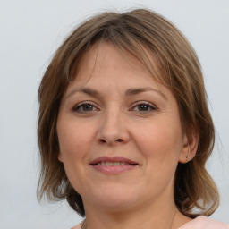 Joyful white adult female with medium  brown hair and brown eyes