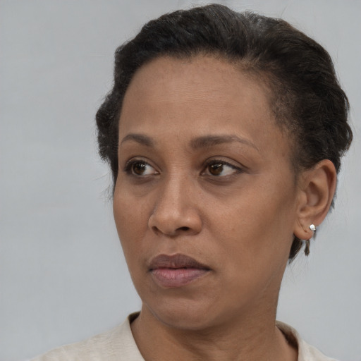 Neutral latino adult female with short  brown hair and brown eyes