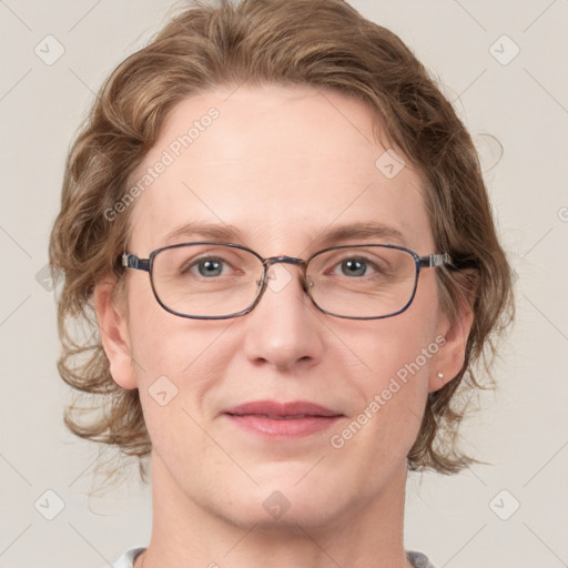 Joyful white adult female with medium  brown hair and blue eyes