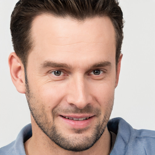 Joyful white young-adult male with short  brown hair and brown eyes