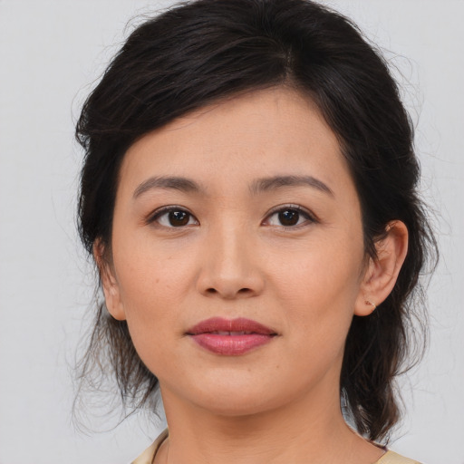 Joyful asian young-adult female with medium  brown hair and brown eyes