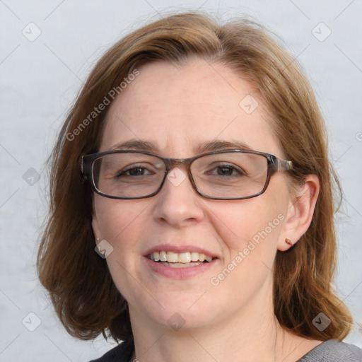 Joyful white adult female with medium  brown hair and blue eyes