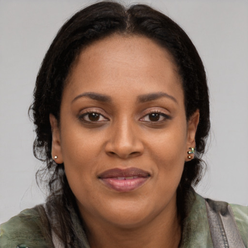 Joyful latino adult female with short  brown hair and brown eyes