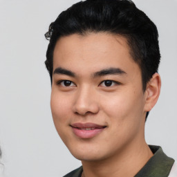 Joyful asian young-adult male with short  black hair and brown eyes