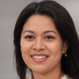 Joyful asian young-adult female with long  brown hair and brown eyes