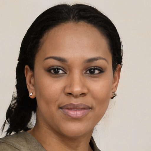 Joyful black young-adult female with medium  brown hair and brown eyes