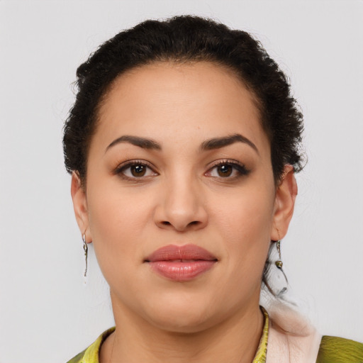 Joyful latino young-adult female with medium  brown hair and brown eyes
