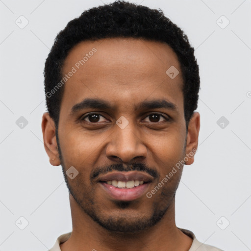 Joyful black young-adult male with short  black hair and brown eyes