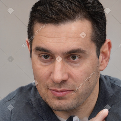 Joyful white adult male with short  brown hair and brown eyes