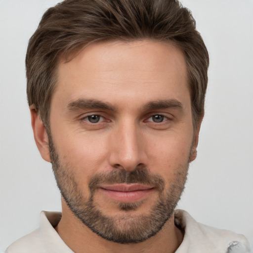 Joyful white young-adult male with short  brown hair and brown eyes