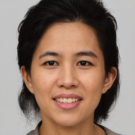 Joyful asian adult female with medium  brown hair and brown eyes