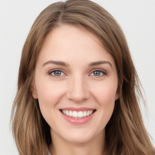 Joyful white young-adult female with long  brown hair and green eyes