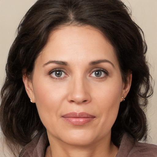 Joyful white adult female with medium  brown hair and brown eyes