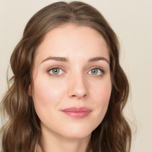 Joyful white young-adult female with long  brown hair and green eyes