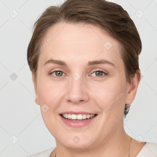 Joyful white young-adult female with short  brown hair and grey eyes