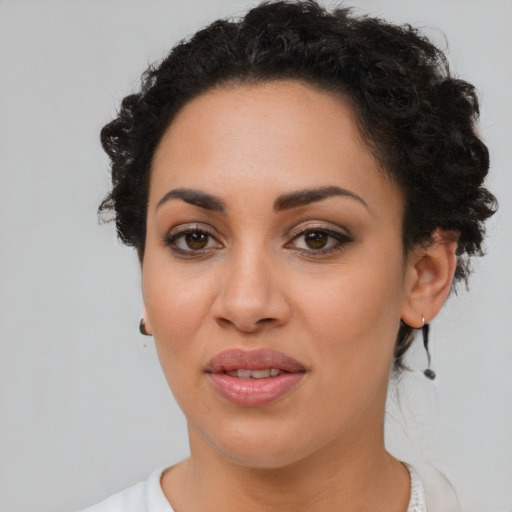 Joyful black young-adult female with short  brown hair and brown eyes