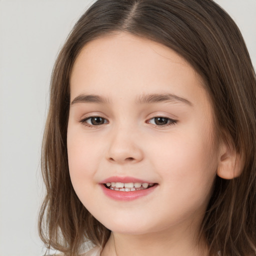 Joyful white child female with long  brown hair and brown eyes